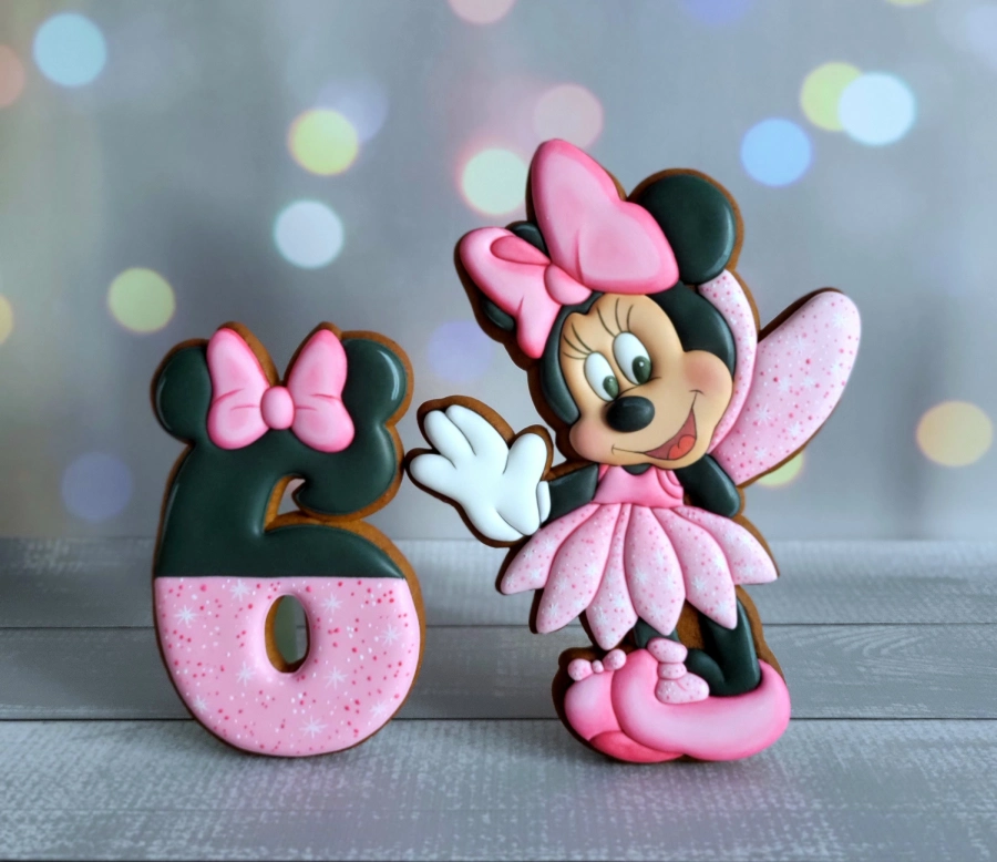 Custom decorated cookies with cartoon characters used as cake toppers