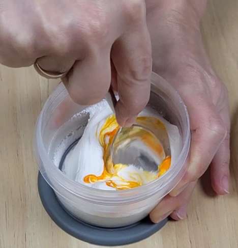 Royal icing after thorough mixing showing smooth uniform color