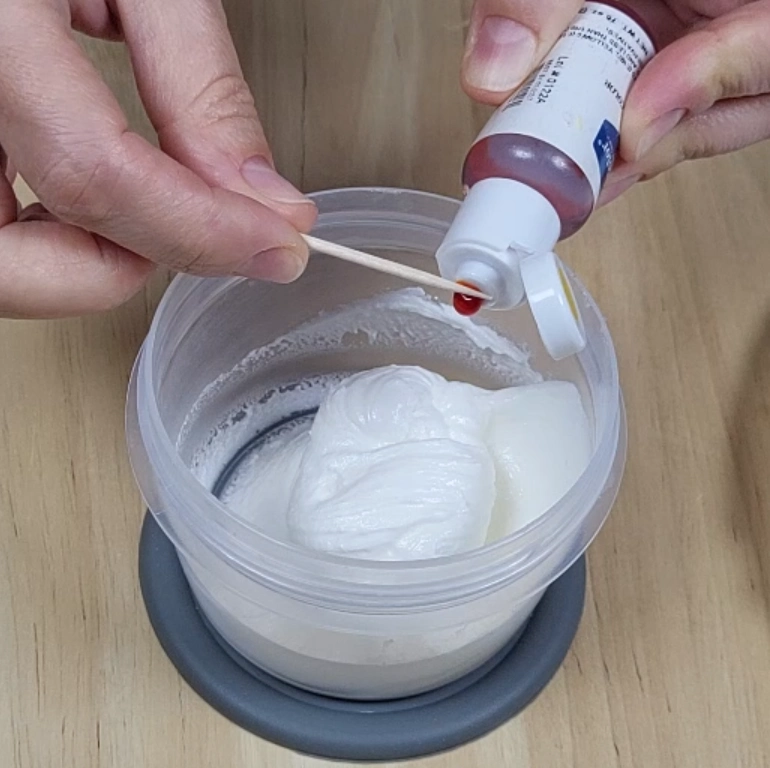 Adding gel food coloring to thick royal icing base consistency