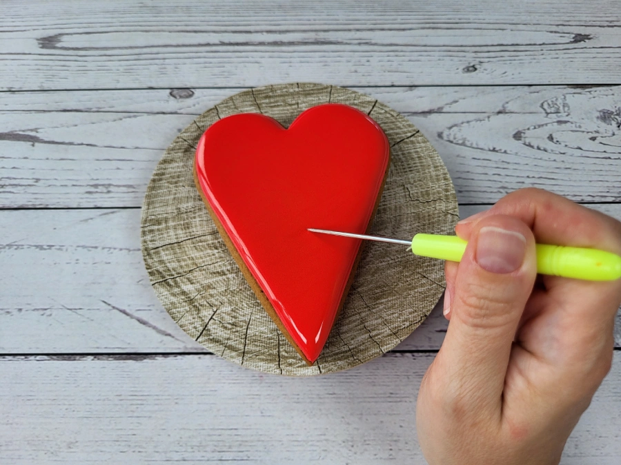 Removing an air bubble from royal icing with a scribe tool